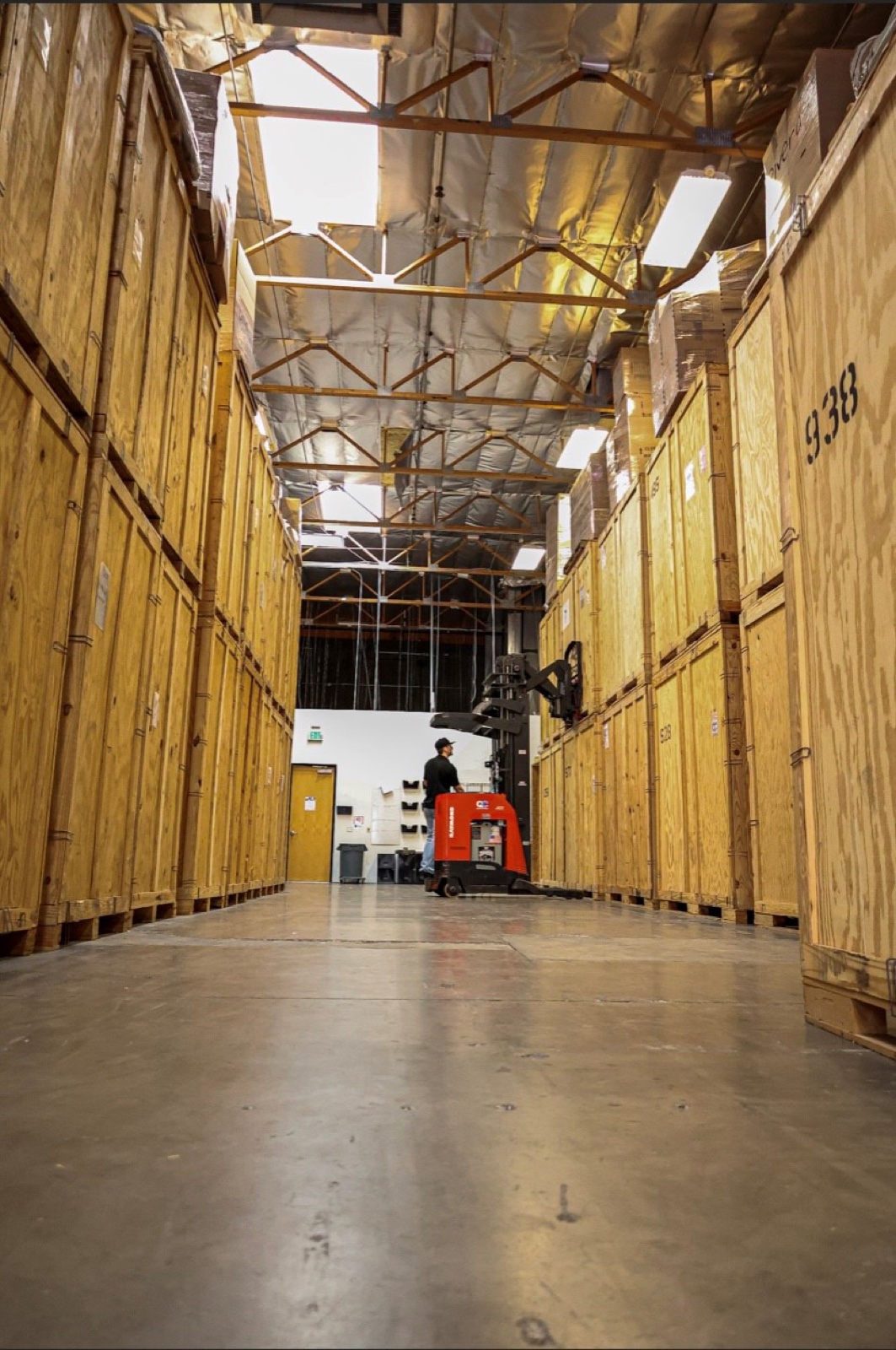 Aisle of numbered wooden storage vaults at the Quality Contents facility where household belongings are stored during restoration